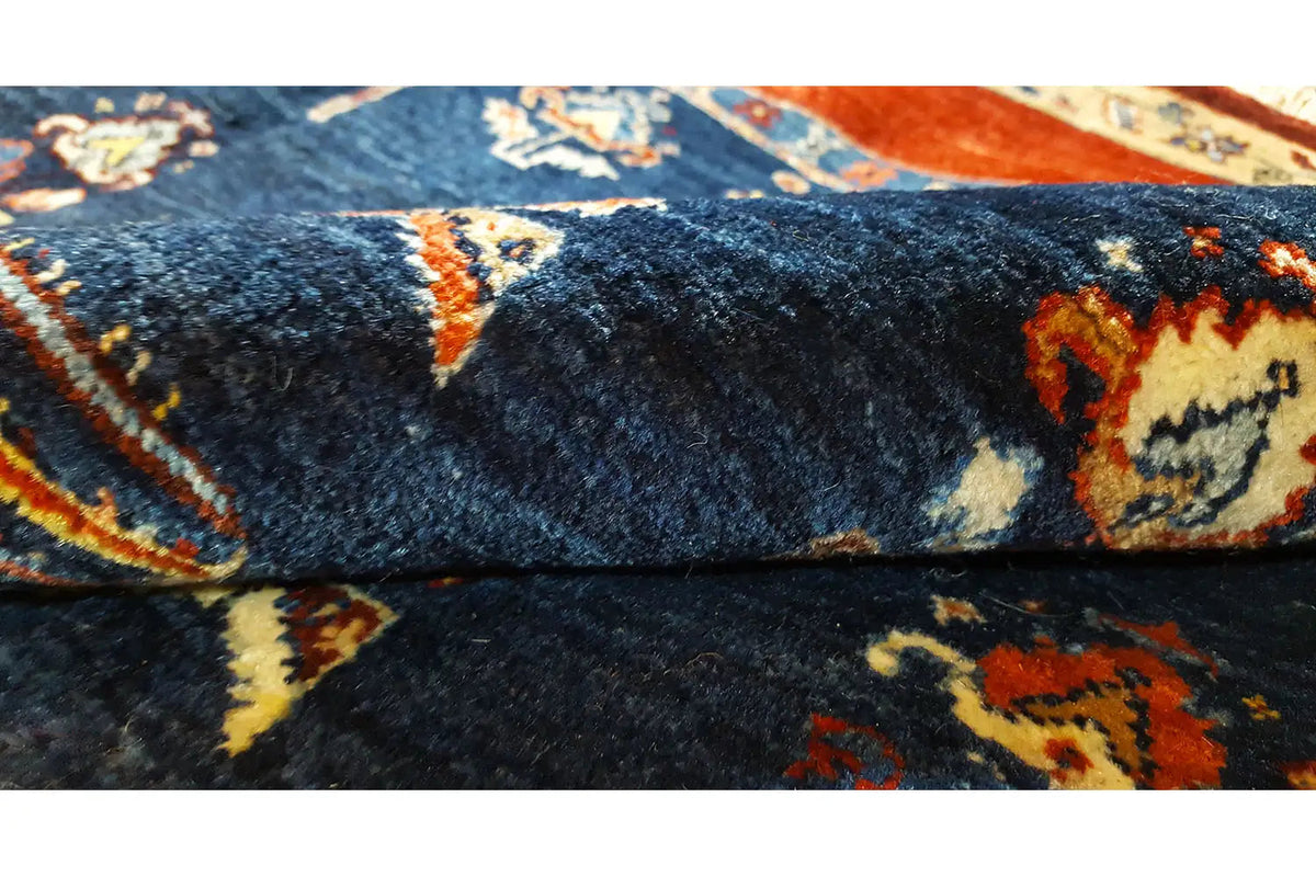 Carpet detail: blue pile with orange and yellow ornaments