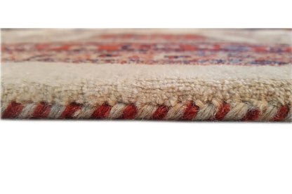 Rug edge with short fringes; dense pile in cream, red, and blue