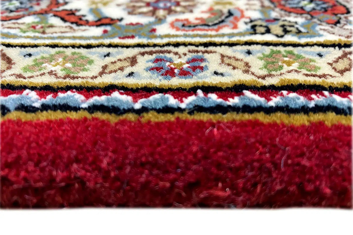 Indo Tabriz carpet (185x125 cm) close-up: red carpet edge with fringes