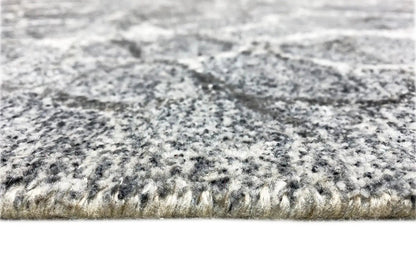 Hand-tufted rug, pile detail at the edge with a gray speckled pattern