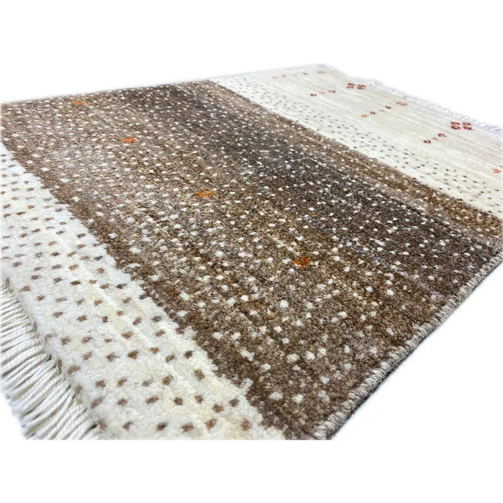 Gabbeh rug 58x43 cm, close-up: dense brown pattern with light dots and accents
