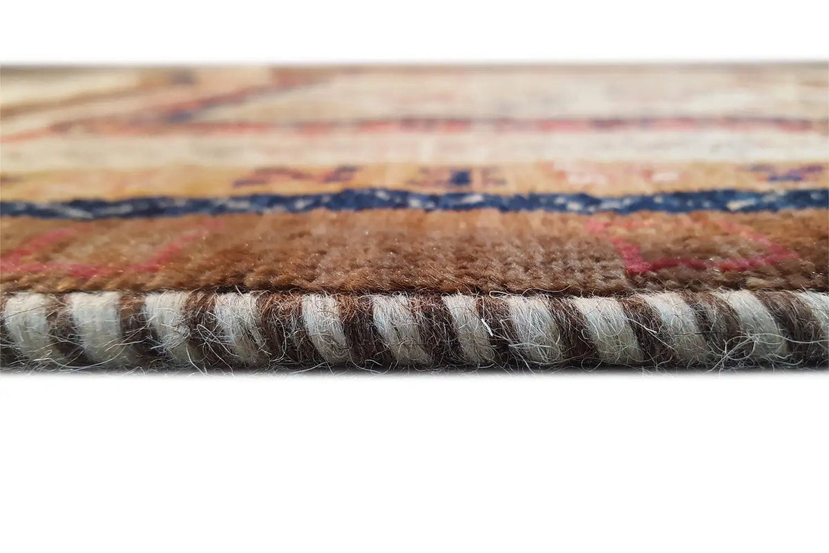 Rug edge with fringe and multicolored border, close-up