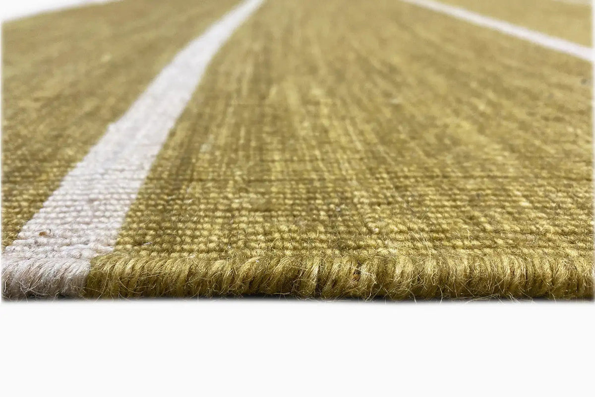 Kilim rug edge detail with short fringes and a white stripe