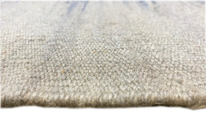 Close-up of a kilim dhurrie rug edge: light texture with short pile and bound edge