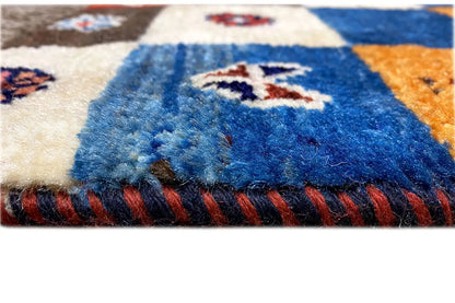 Gabbeh-Lori rug detail: blue pile fibers and red fringes along the rug's edge