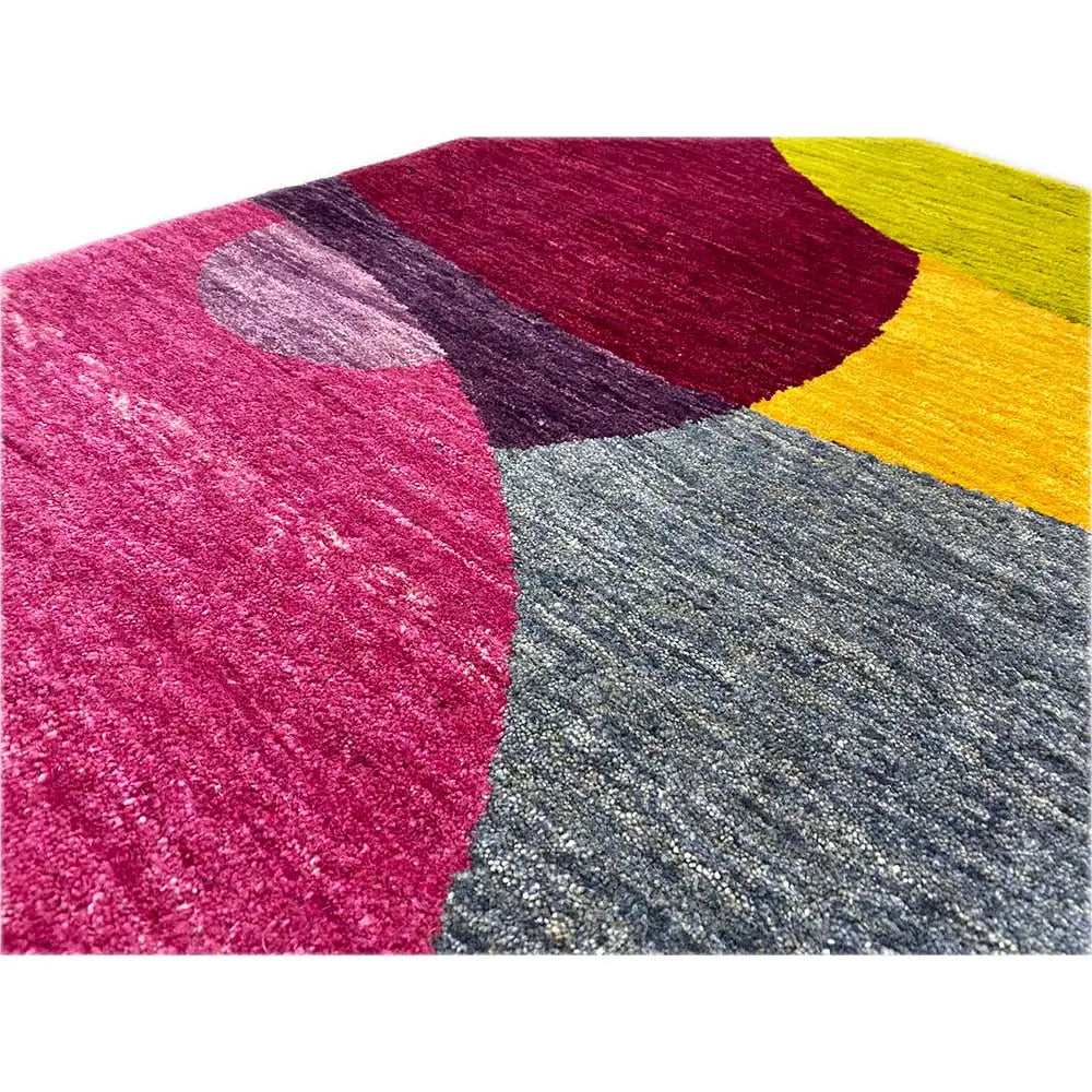 Gabbeh rug detail: large bands of color in magenta, gray, yellow and dark red