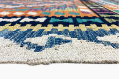 Kilim detail with pile height and fringe, blue-and-white decorative motifs along the edge