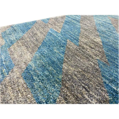 Rug detail with a heathered texture and wide blue and gray stripes, 90x55 cm
