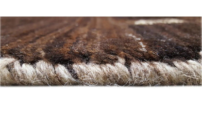 Close-up of the Gabbeh rug: dense wool fibers, brown-beige texture in the pile