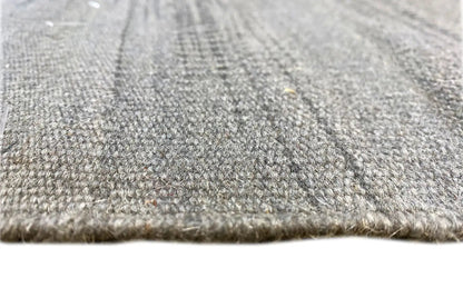 Close-up: gray kilim dhurrie rug, woven texture and short fringes