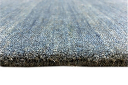 Blue carpet edge with short fringes, visible pile texture