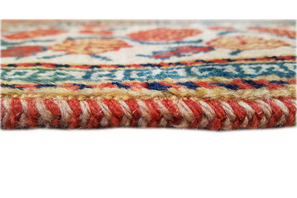 Oriental rug edge with multicolored border and short fringe trim