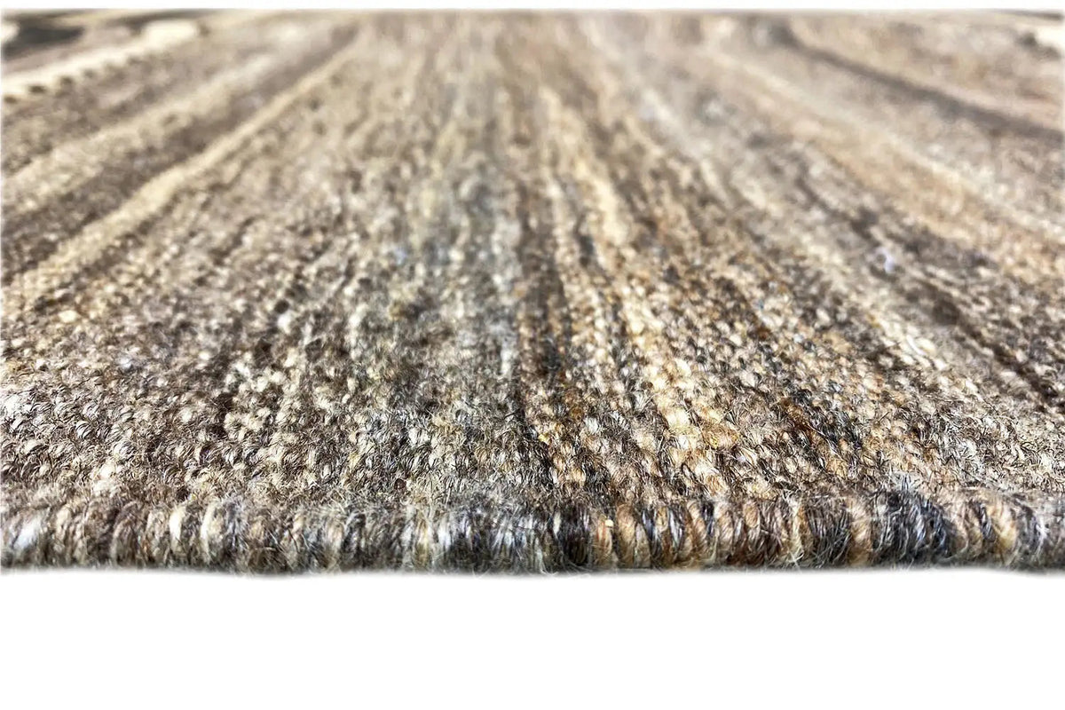 Gray and beige carpet pile with a mottled surface, finely woven, dense texture.