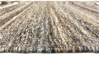 Gray and beige carpet pile with a mottled surface, finely woven, dense texture.