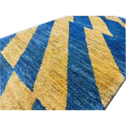 Close-up: Gabbeh rug made of virgin wool with yellow and blue zigzag stripes and a dense pile
