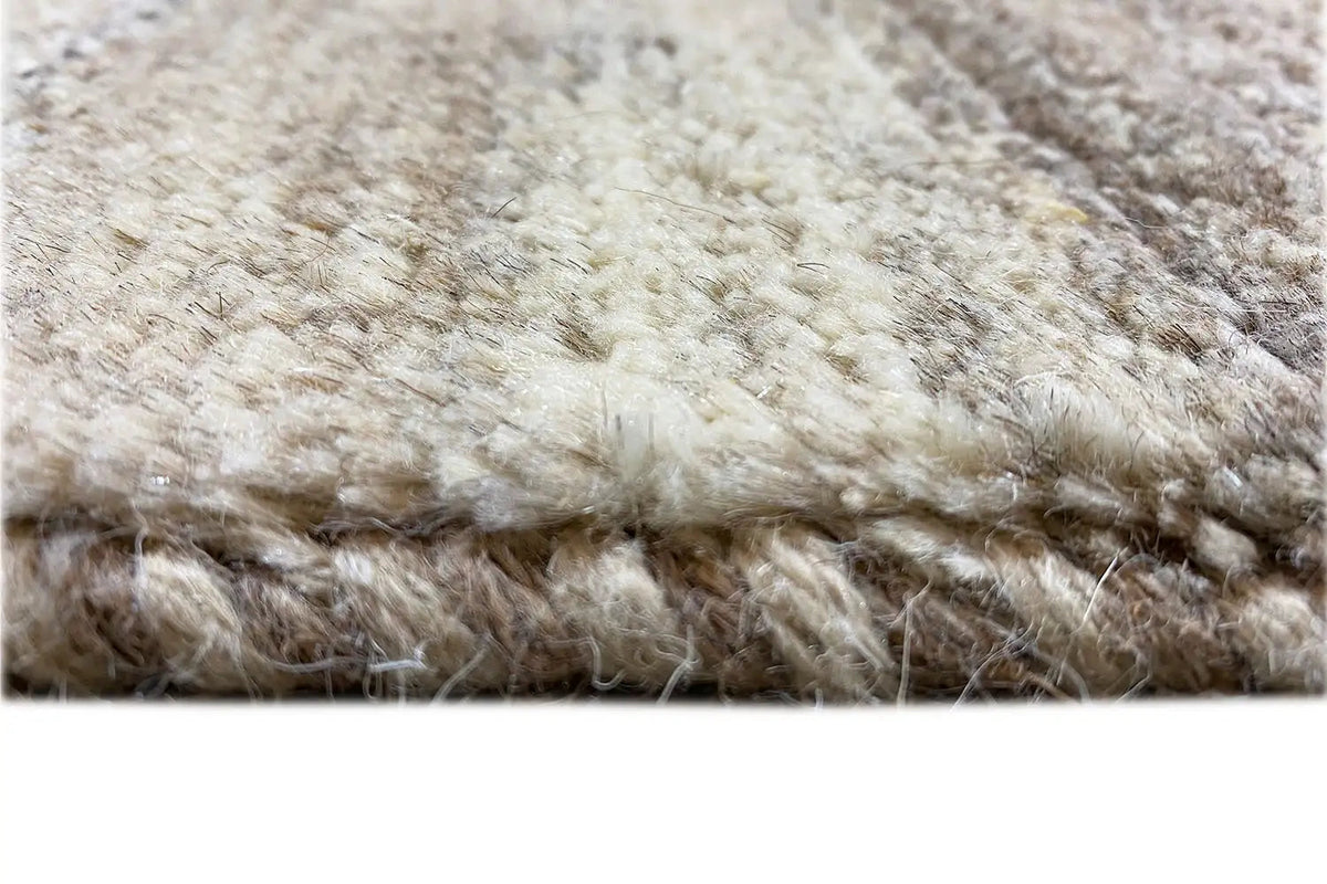 Gabbeh rug (193x156 cm) Detail of the pile height and fringe along the edge, beige-gray