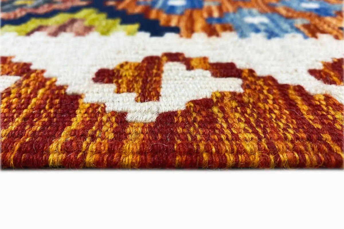 Afghan kilim close-up pile: white area and copper-red patterned color fields