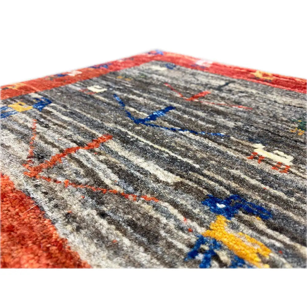 Gabbeh rug detail: gray stripes with red, blue, and yellow ornamental lines