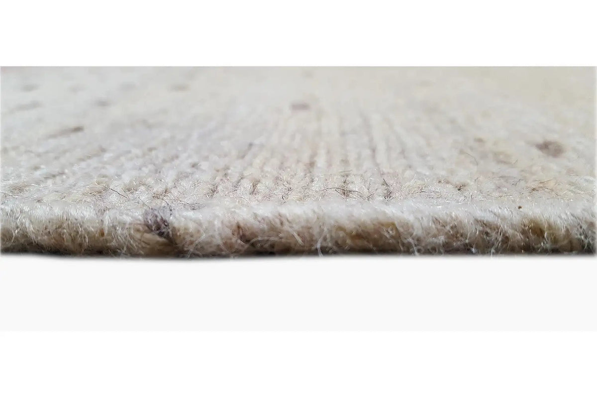 Kilim rug detail: fine beige texture with a short pile and woven edge