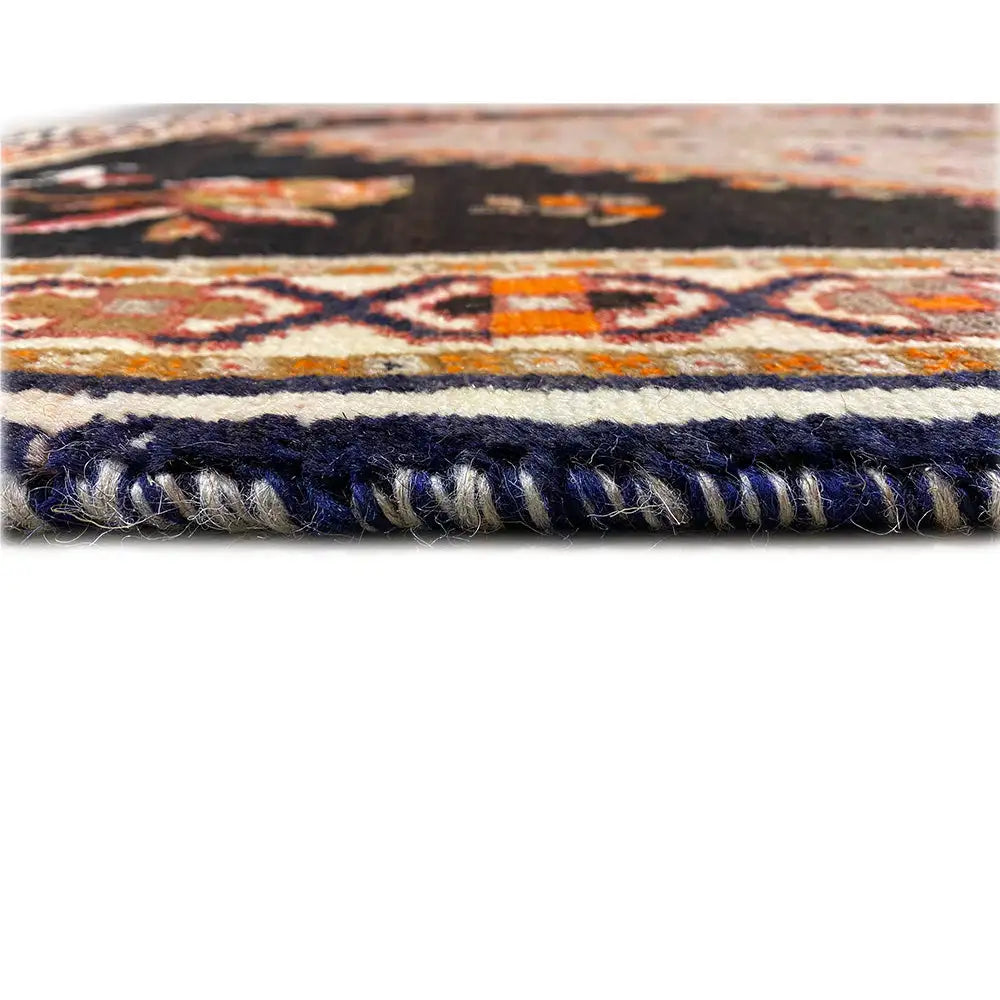 Carpet edge with dark decorative fringes and a mottled pile surface