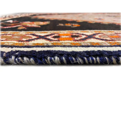 Carpet edge with dark decorative fringes and a mottled pile surface