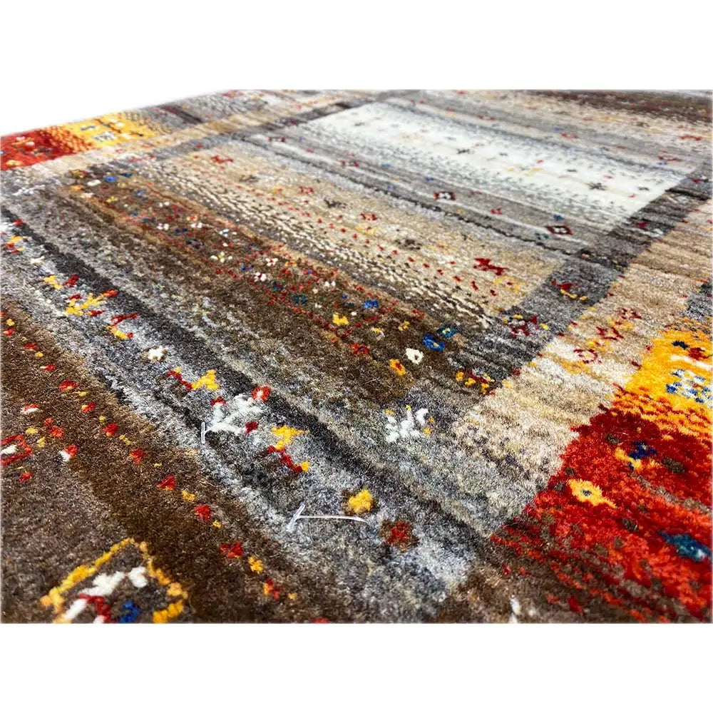 Close-up of a Gabbeh rug: multicolored embroidery in a striped design