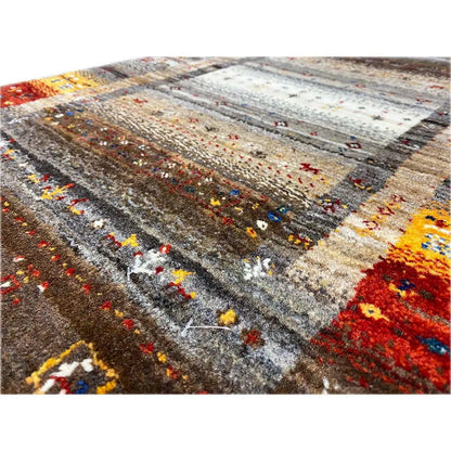 Close-up of a Gabbeh rug: multicolored embroidery in a striped design