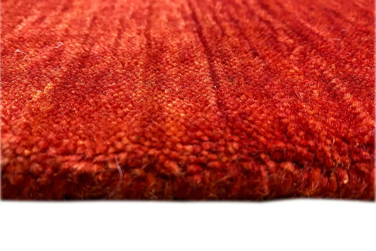 Red Gabbeh rug, pile detail with dense fiber texture and short loop pile height