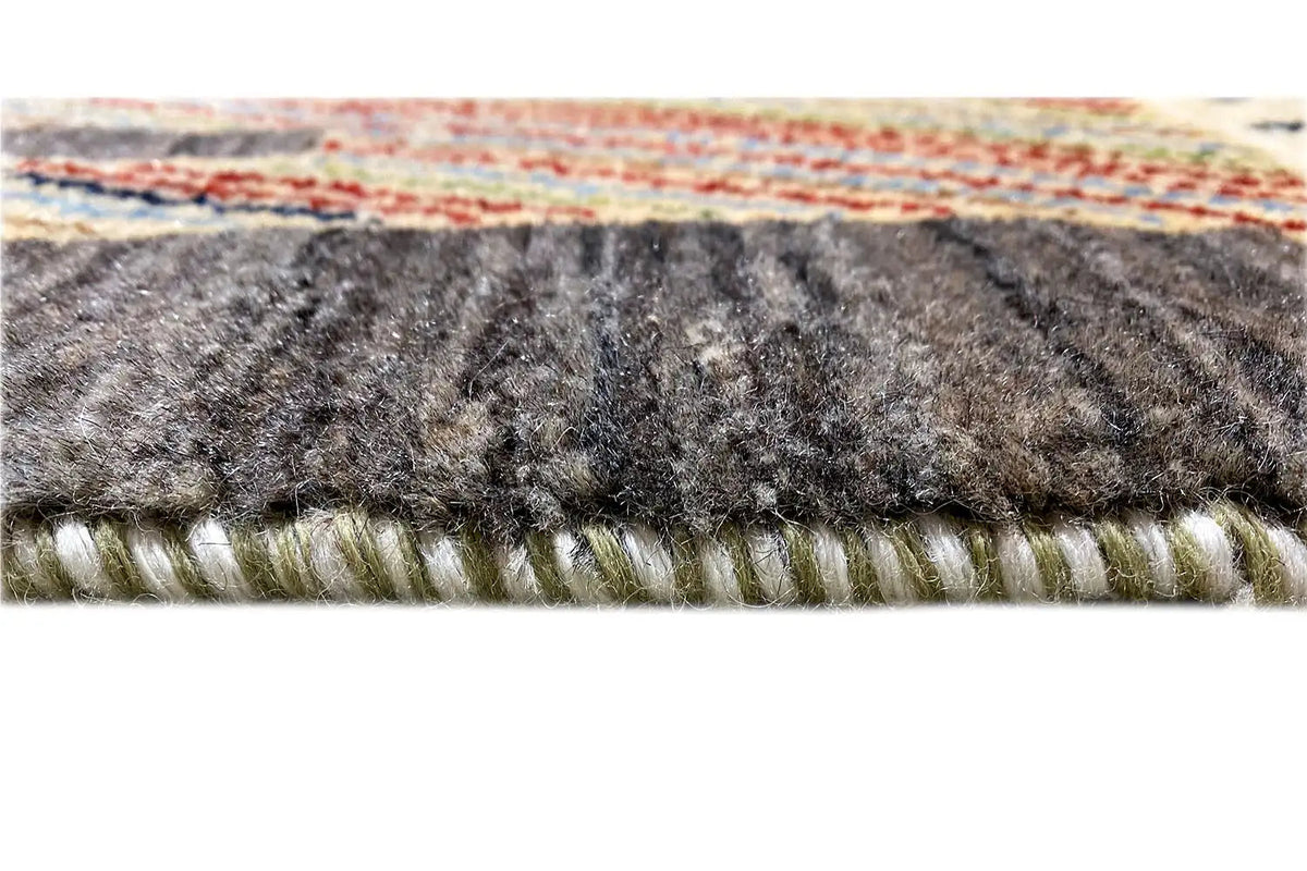 Gabbeh Lori rug close-up of the edge with dark pile and a bound hem