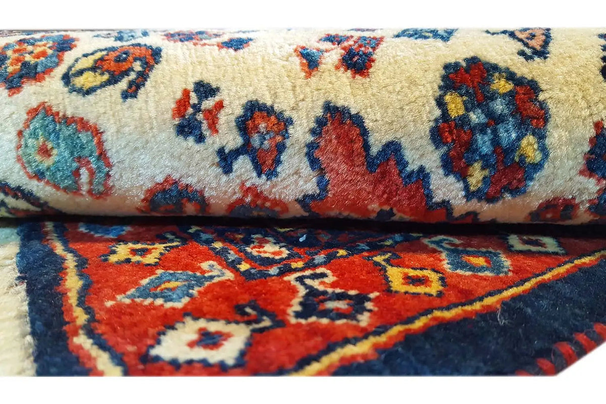 Qashqai exclusive carpet detail: multicolored ornaments on a beige background