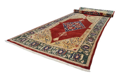 Oriental rug laid out with a red central motif and colorful border ornaments