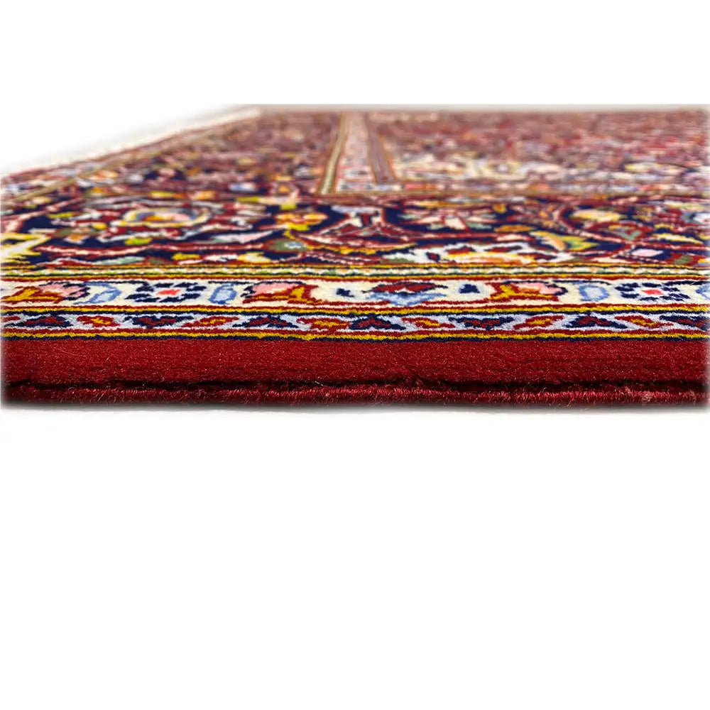 Keshan rug edge with dense pile and embroidered border, side view