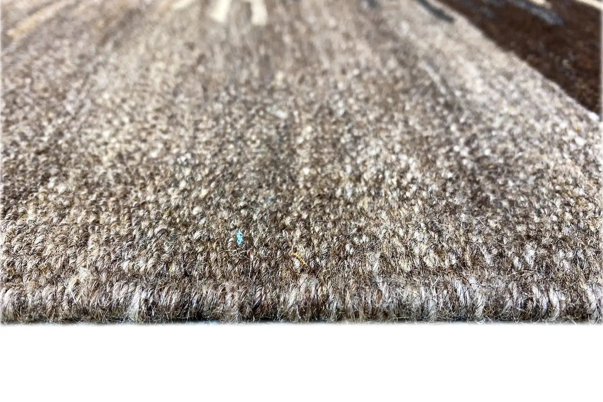 Kilim rug detail: woven pile with fringes, gray-beige and dark threads