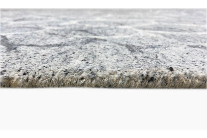 Hand-tufted rug, side view: dense pile with a woven edge