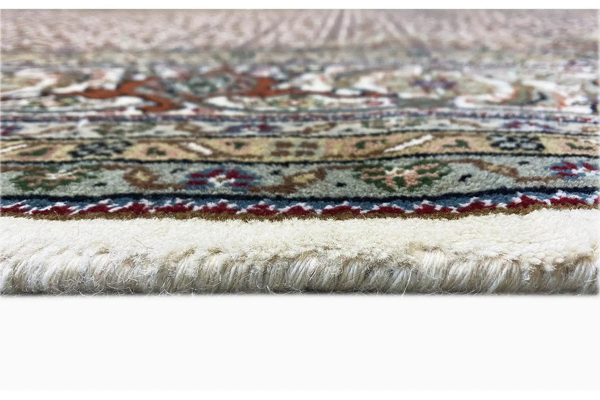 Carpet edge with a multicolored striped pattern, light pile, and fringes
