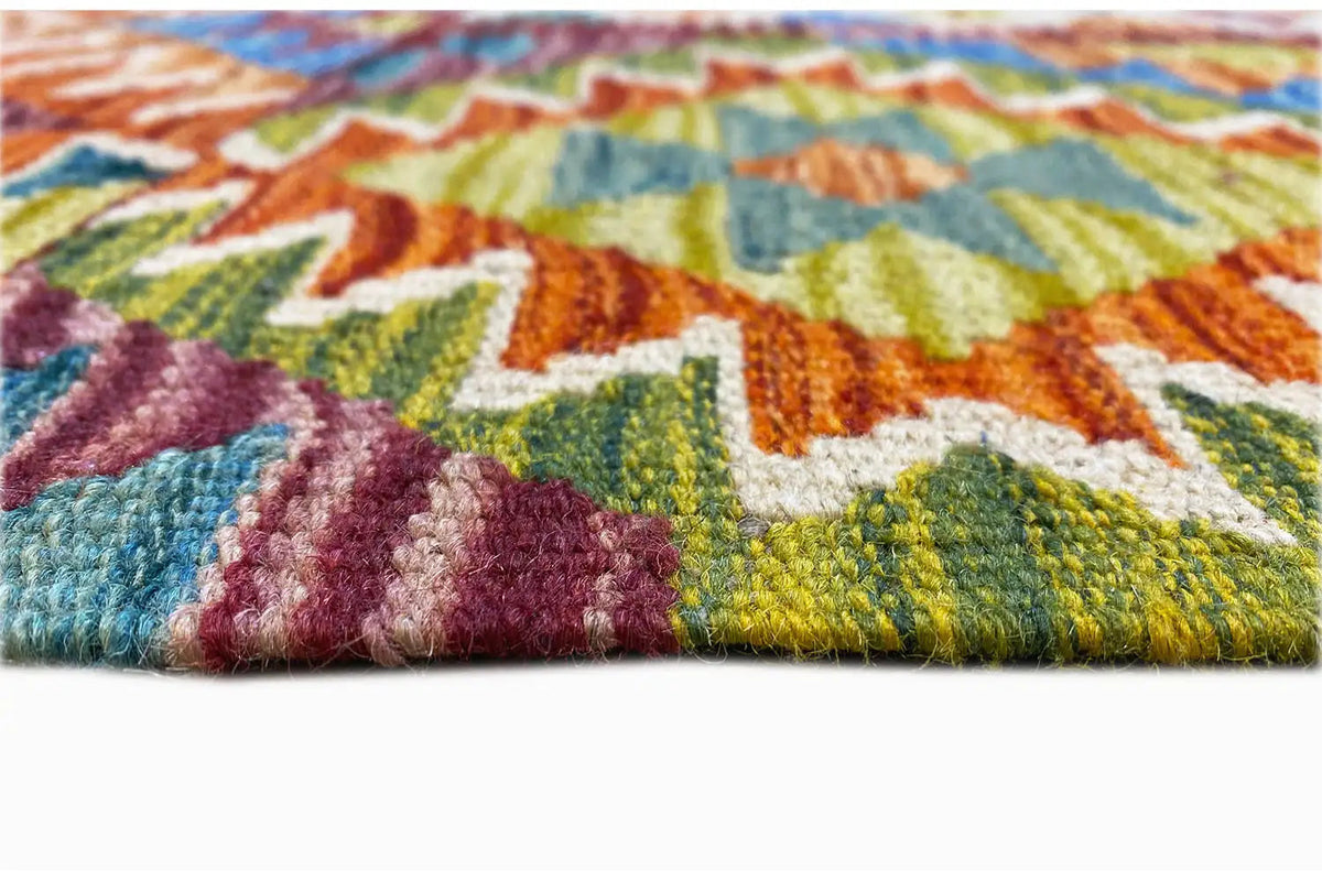Afghan kilim detail at the hem with multicolored woven texture and short fringe