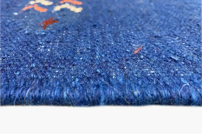 Blue carpet edge with short pile and fine texture, close-up