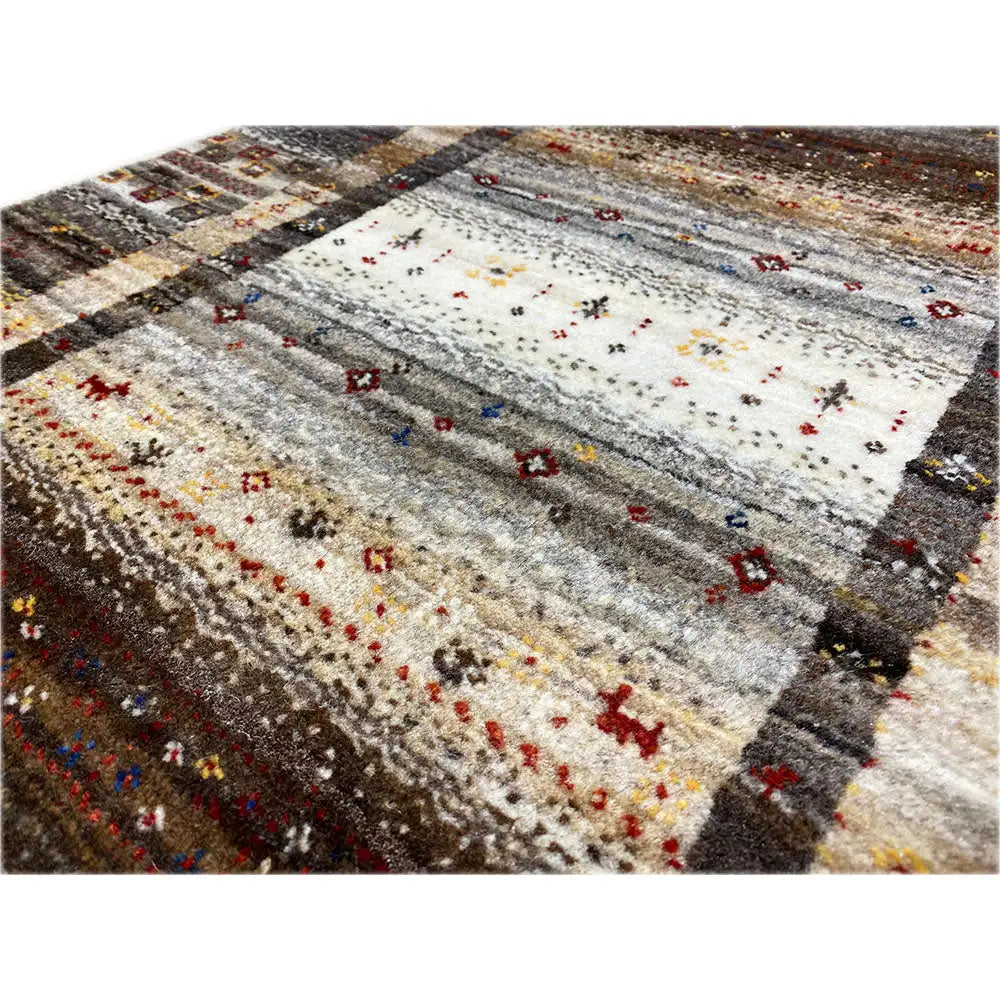 Gabbeh rug detail view: knotted pile, light central medallion with colorful dots