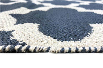 Kilim rug edge detail with a visible woven pattern and short fringes