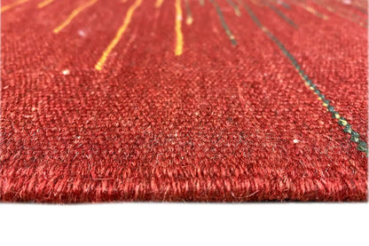 Kilim rug close-up: red pile with fine fiber textures and green accents