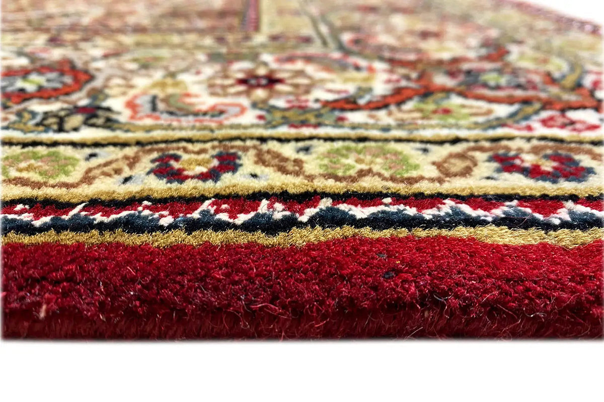 Indo Tabriz rug close-up: colorful ornamental border, dense pile