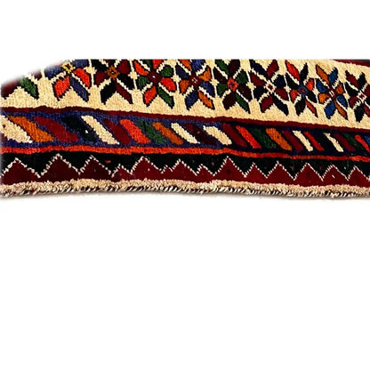 Close-up of the selvedge of a Shiraz carpet with fringes and a colorful striped pattern