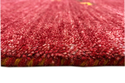 Red Gabbeh rug, detail of the dense pile and edge with fringe