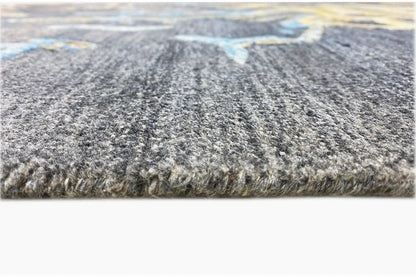 Hand-tufted rug in detail: short blue-gray pile with dense edge fringing
