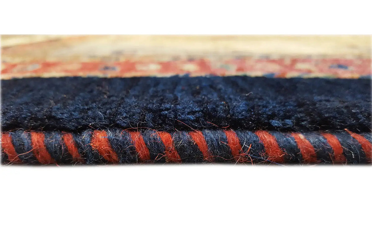 Carpet edge with dark binding and orange accents in the pile.