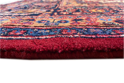 Rug edge with a short fringe trim in vibrant red, fine pile