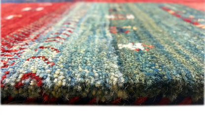 Close-up: carpet pile with colorful threads in red, blue, and green