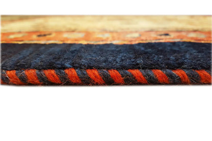 Carpet edge with dense decorative fringe in black and orange, border detail
