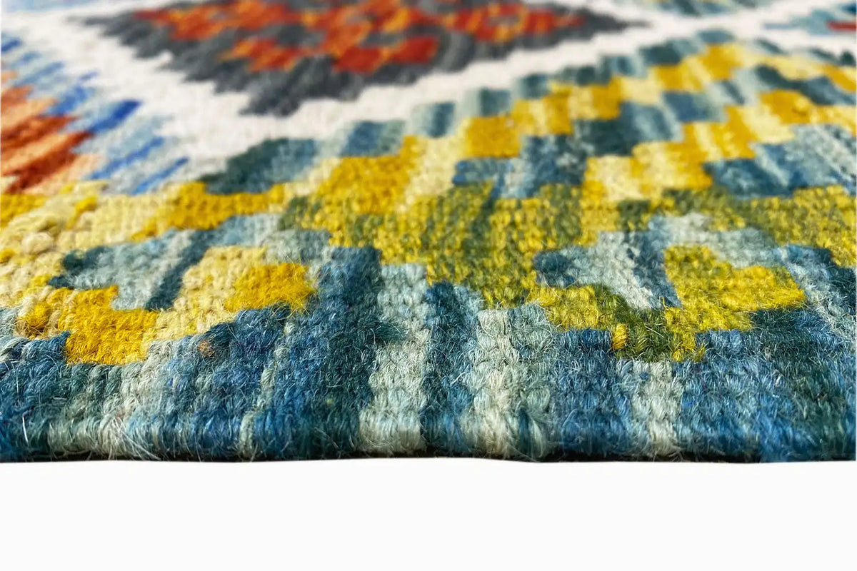 Afghan kilim runner: close-up of the woven pile and multicolored border