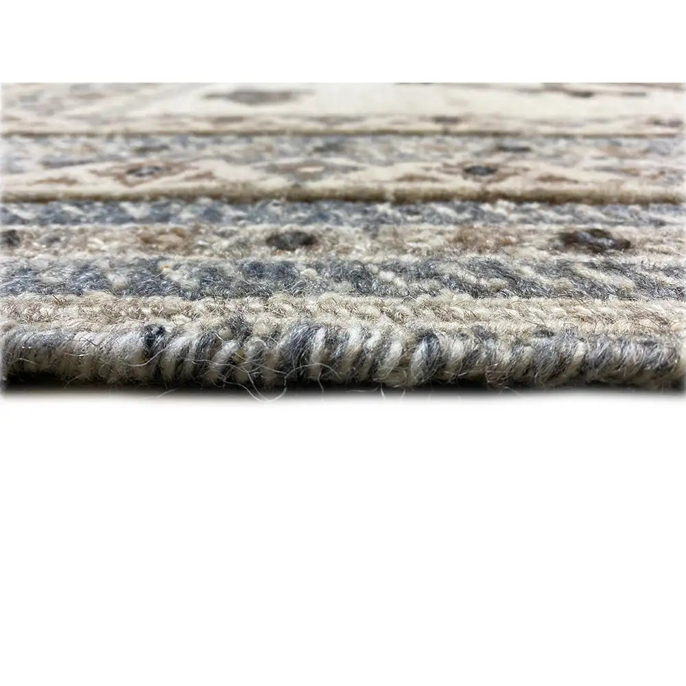 Carpet pile in close-up: thick, mixed fiber texture in light beige and blue-gray